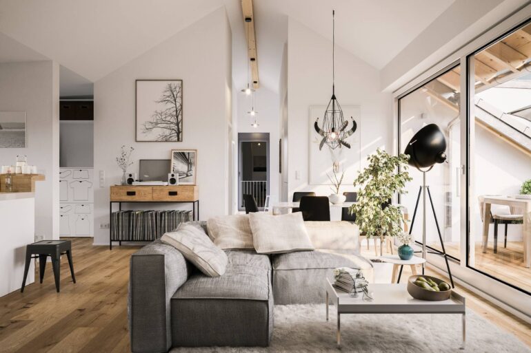 A modern living room with a grey couch, wooden floors, stylish light fixtures, an interior plant, and large sliding doors.