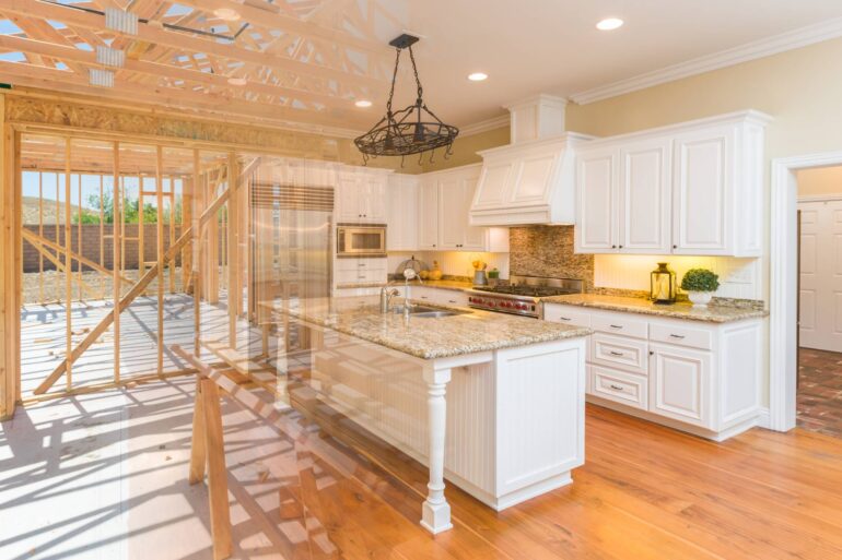 A gradient picture of a home in the middle of construction transforming into a fully remodeled kitchen.