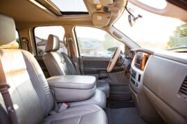 An interior shot of a pickup truck with lots of legroom, luxurious leather seats, and a lot of light flooding in.