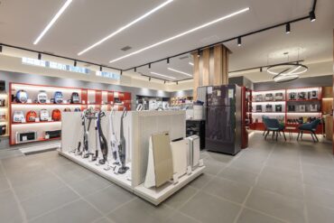 The inside of a retail store contains items such as vacuums, a refrigerator, and coffee machines.