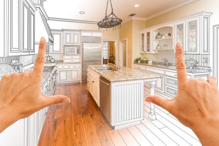 Close-up of a pair of hands forming a finger frame in front of a partially done kitchen. Some portions are still a sketch.