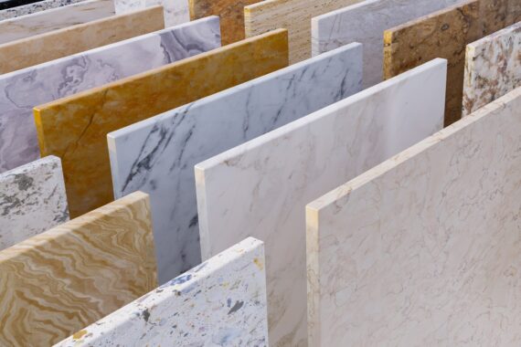 A display of stone countertop samples arranged in a showroom with multiple types of surfaces visible.